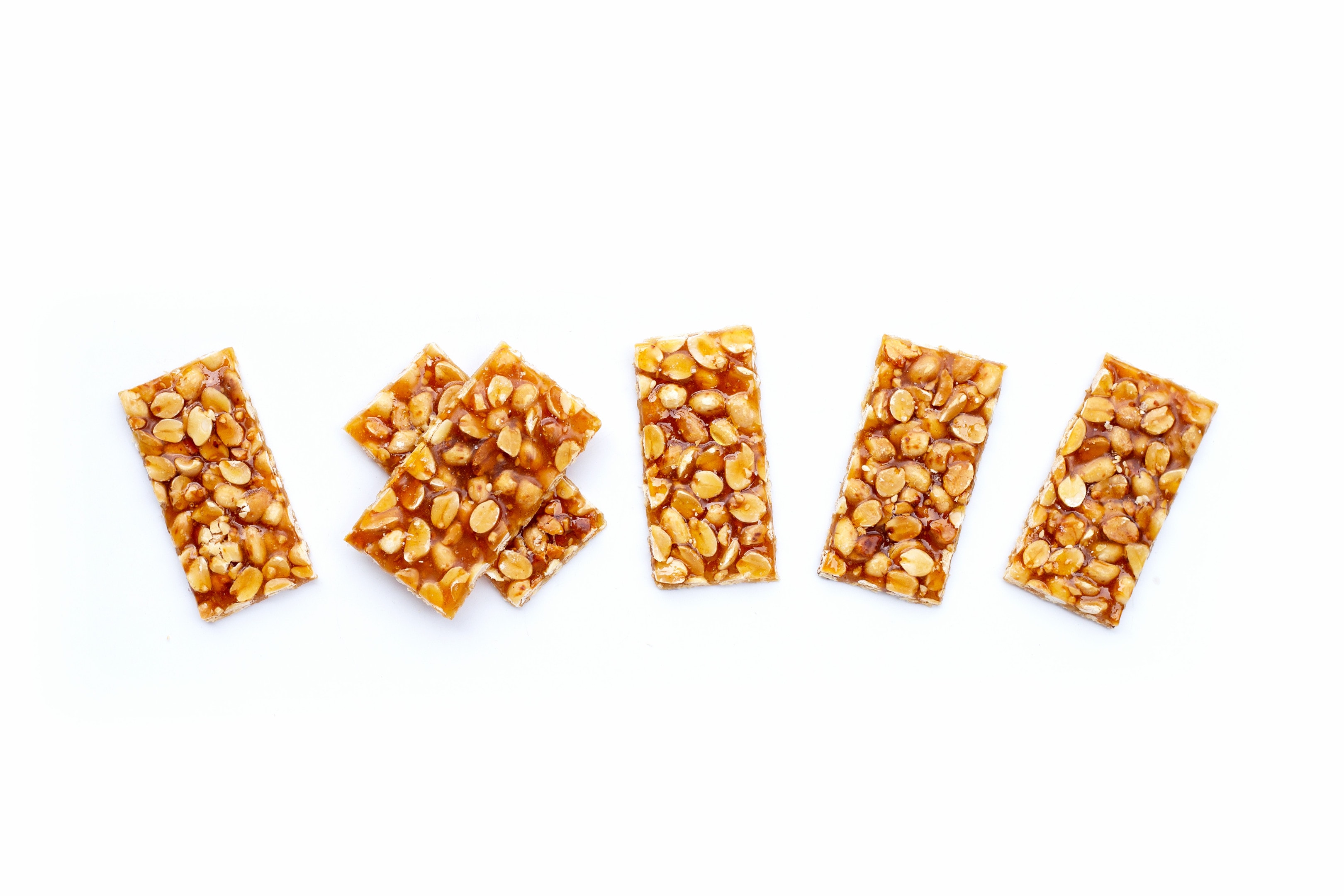 Kadalai mittai — peanuts and jaggery bars on white background