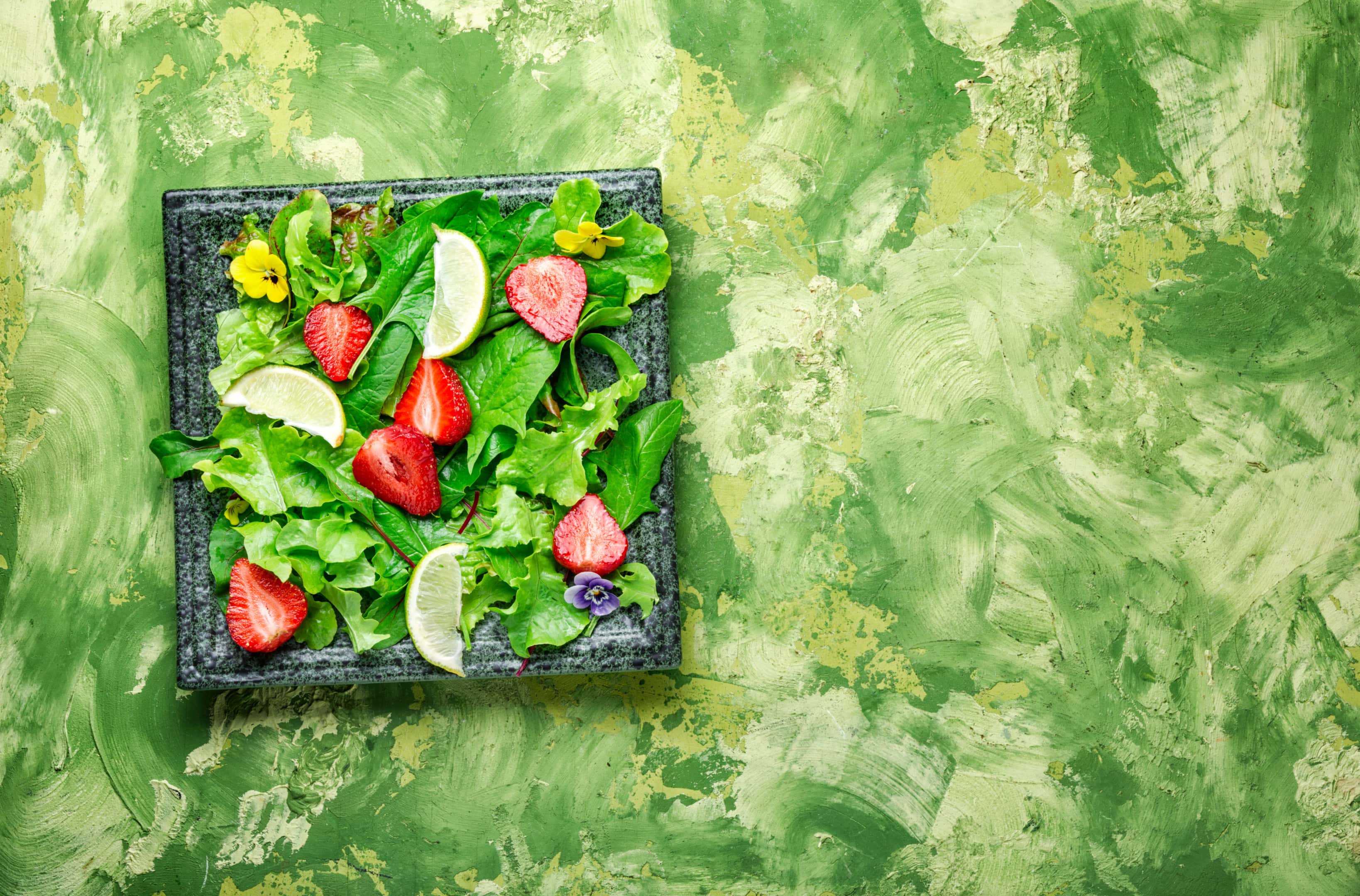 Leafy green summer salad with strawberries
