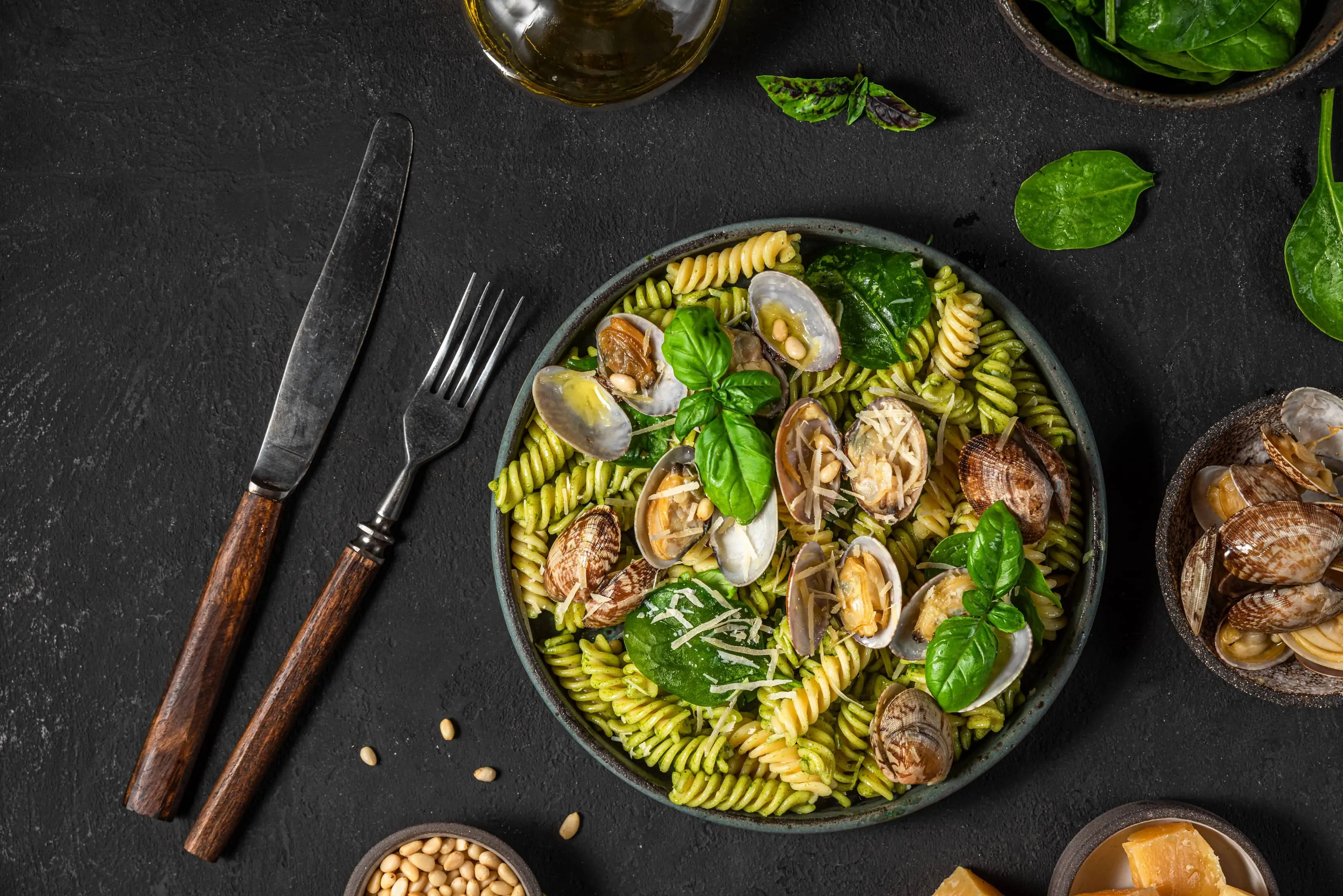 Seafood pasta with vongole clams, spinach parmesan cheese, pine nuts and basil