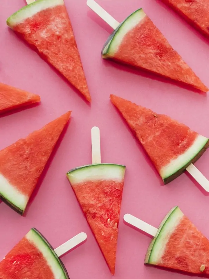 Watermelons on sticks on pink background