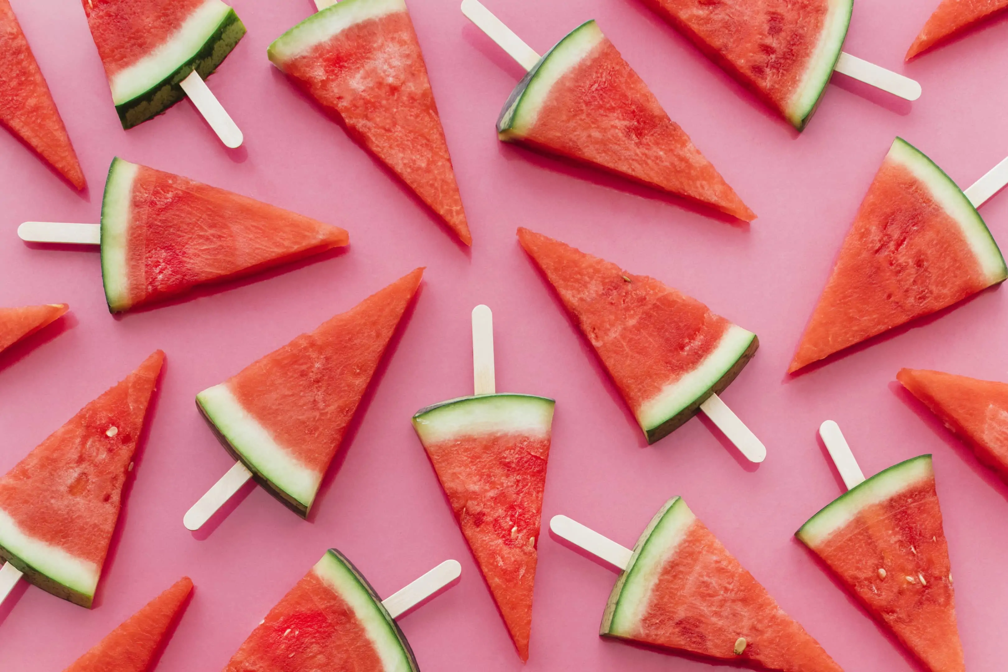 Watermelons on sticks on pink background