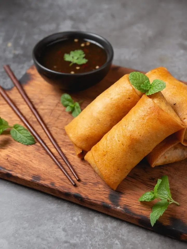 Fried spring rolls on a cutting board