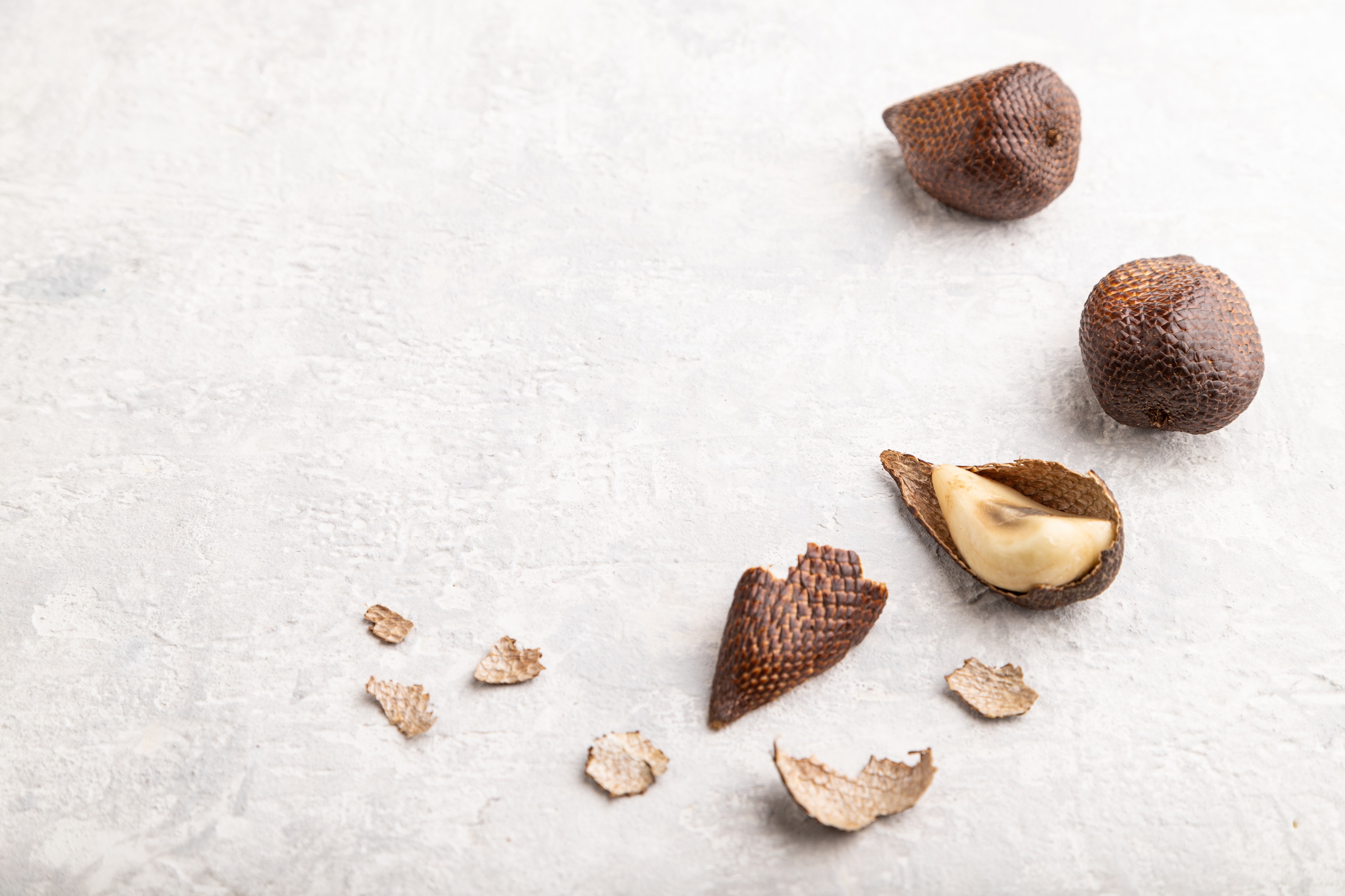 Salak — snake fruit — on a gray table