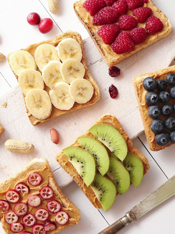 Assortment of healthy fresh breakfast toasts with peanut butter and fruits