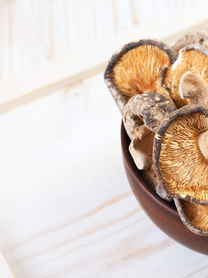 Close up of dried shiitake mushrooms in wooden bowl