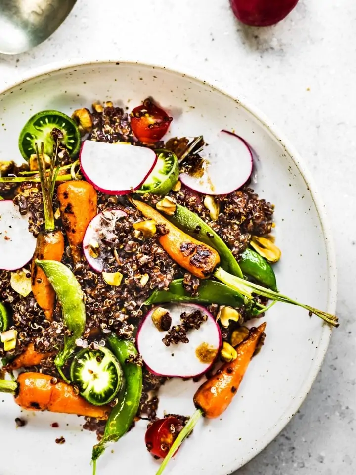 Quinoa salad with grilled baby carrot ,snap pea, radish and pistachio oil