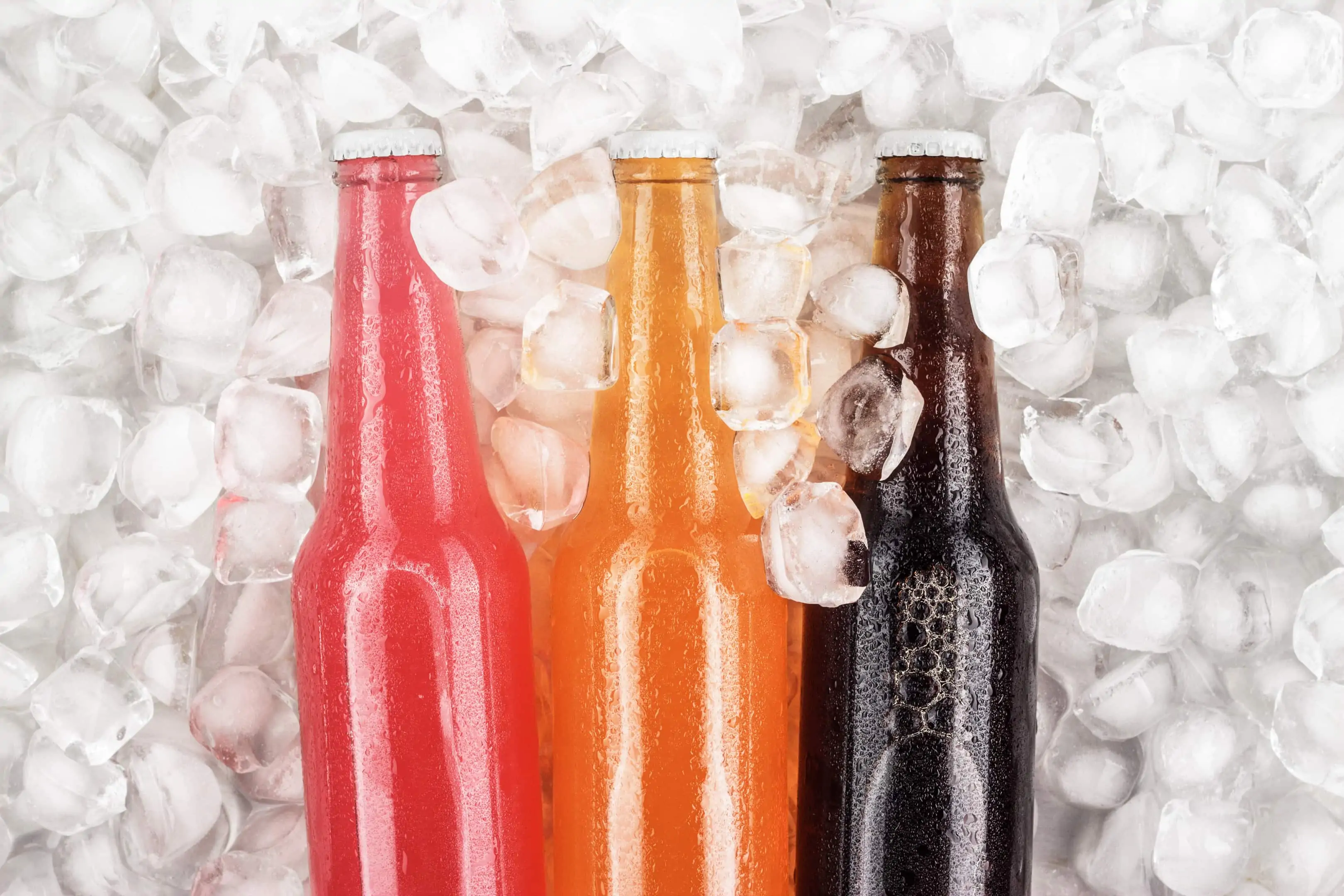 Sugar drinks in glass bottles over ice