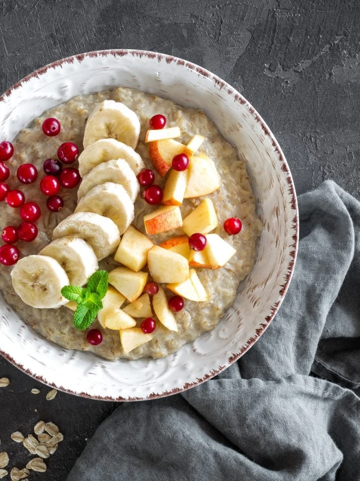 Oatmeal porridge with banana, apple and pomegranate