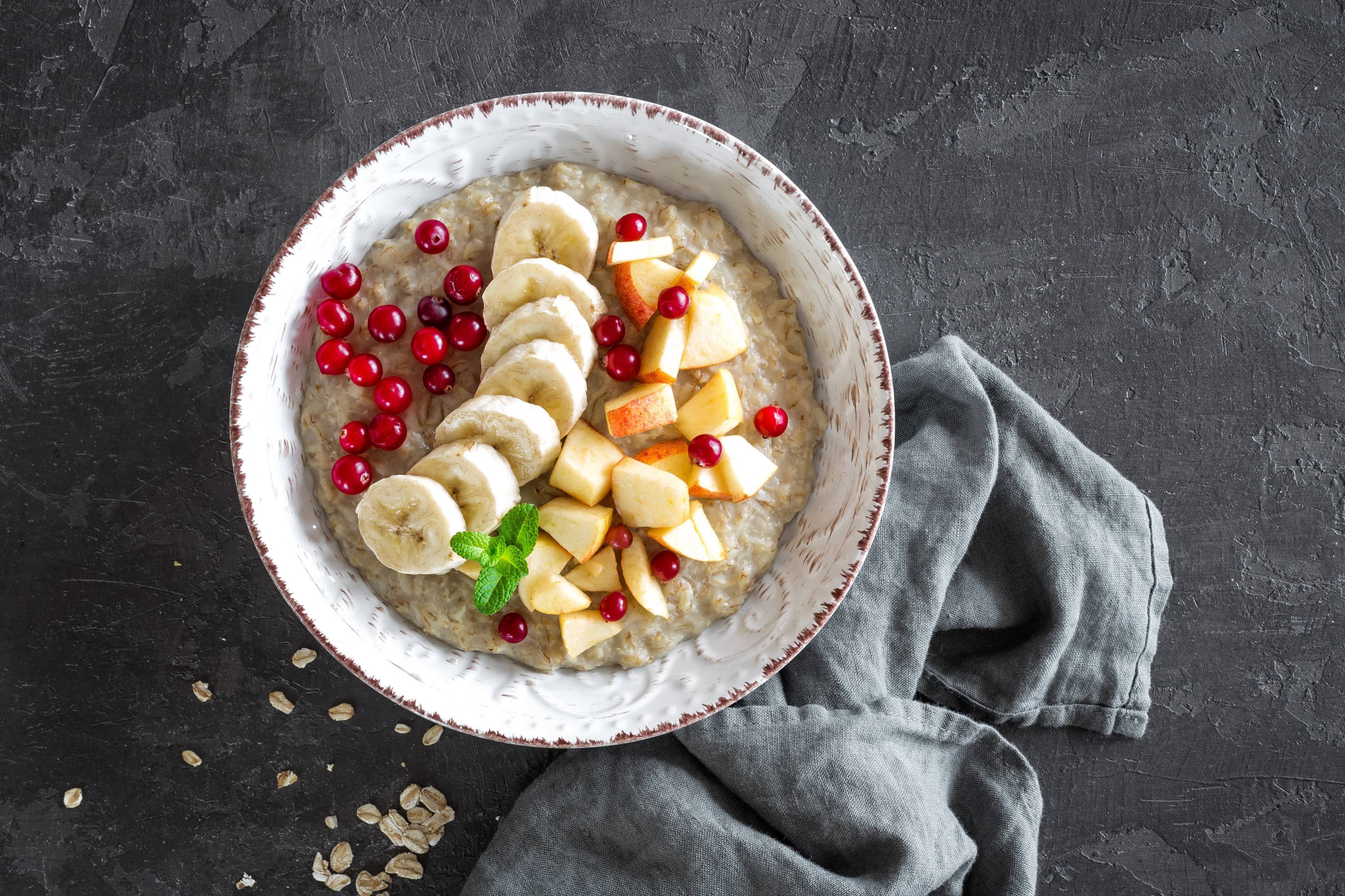 Oatmeal porridge with banana, apple and pomegranate