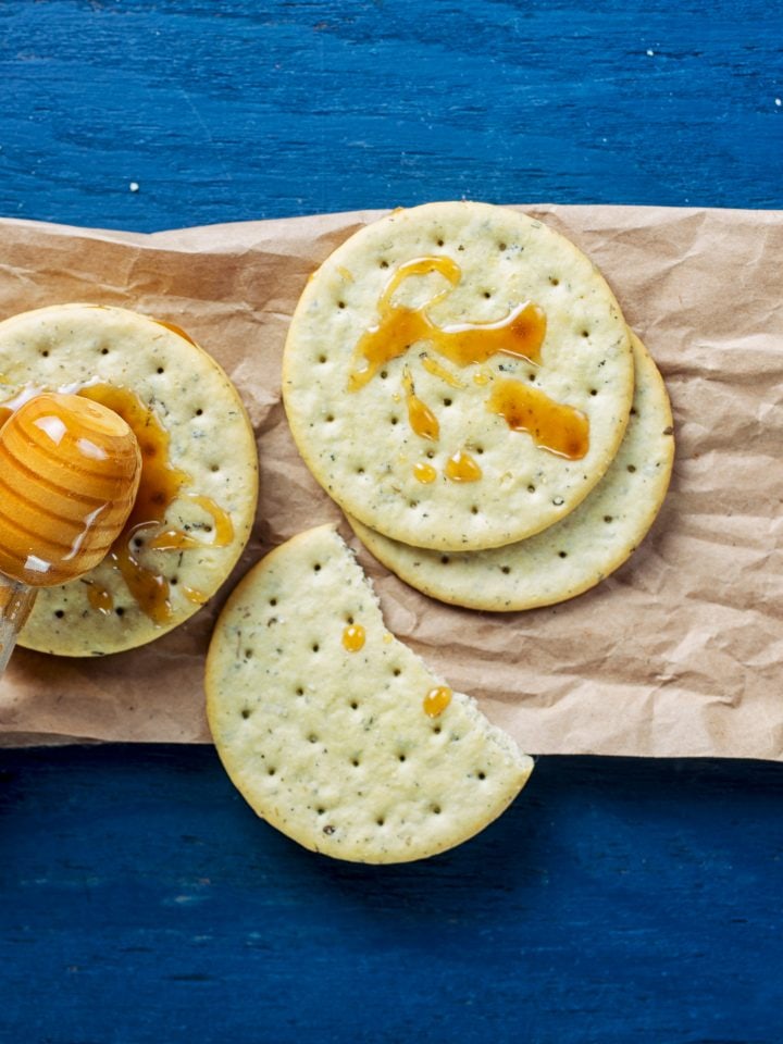 Crackers with honey on a blue background