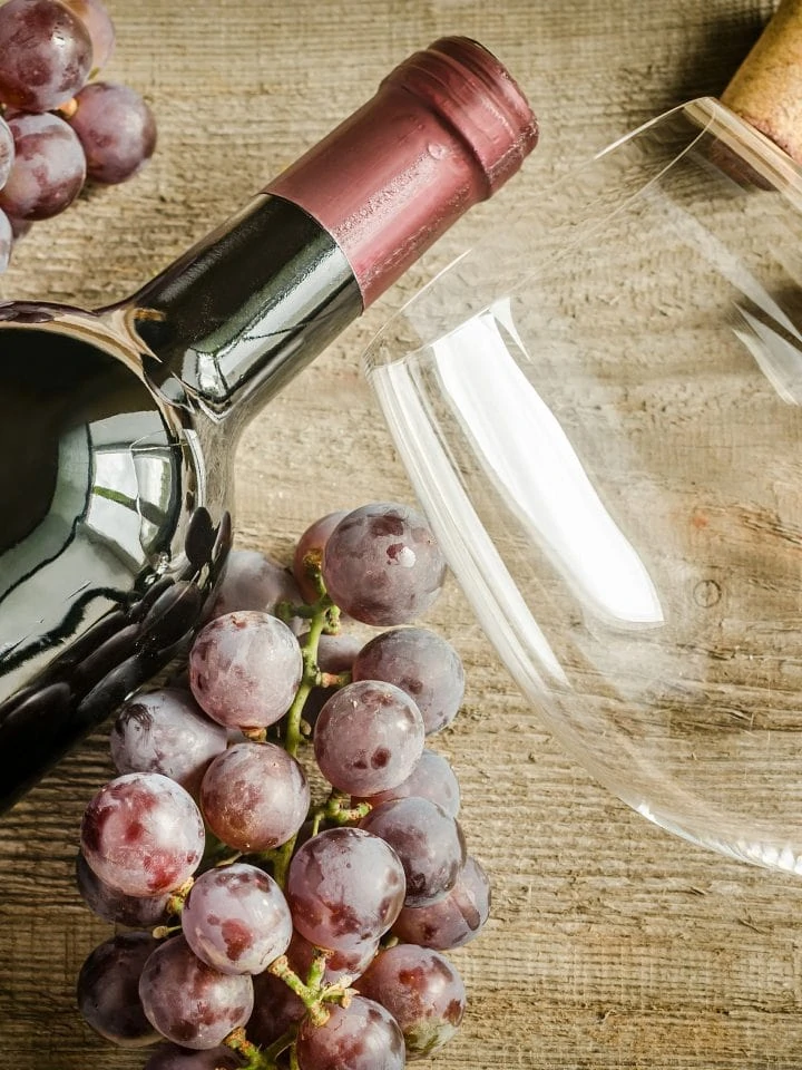 Bottle of red wine with grapes