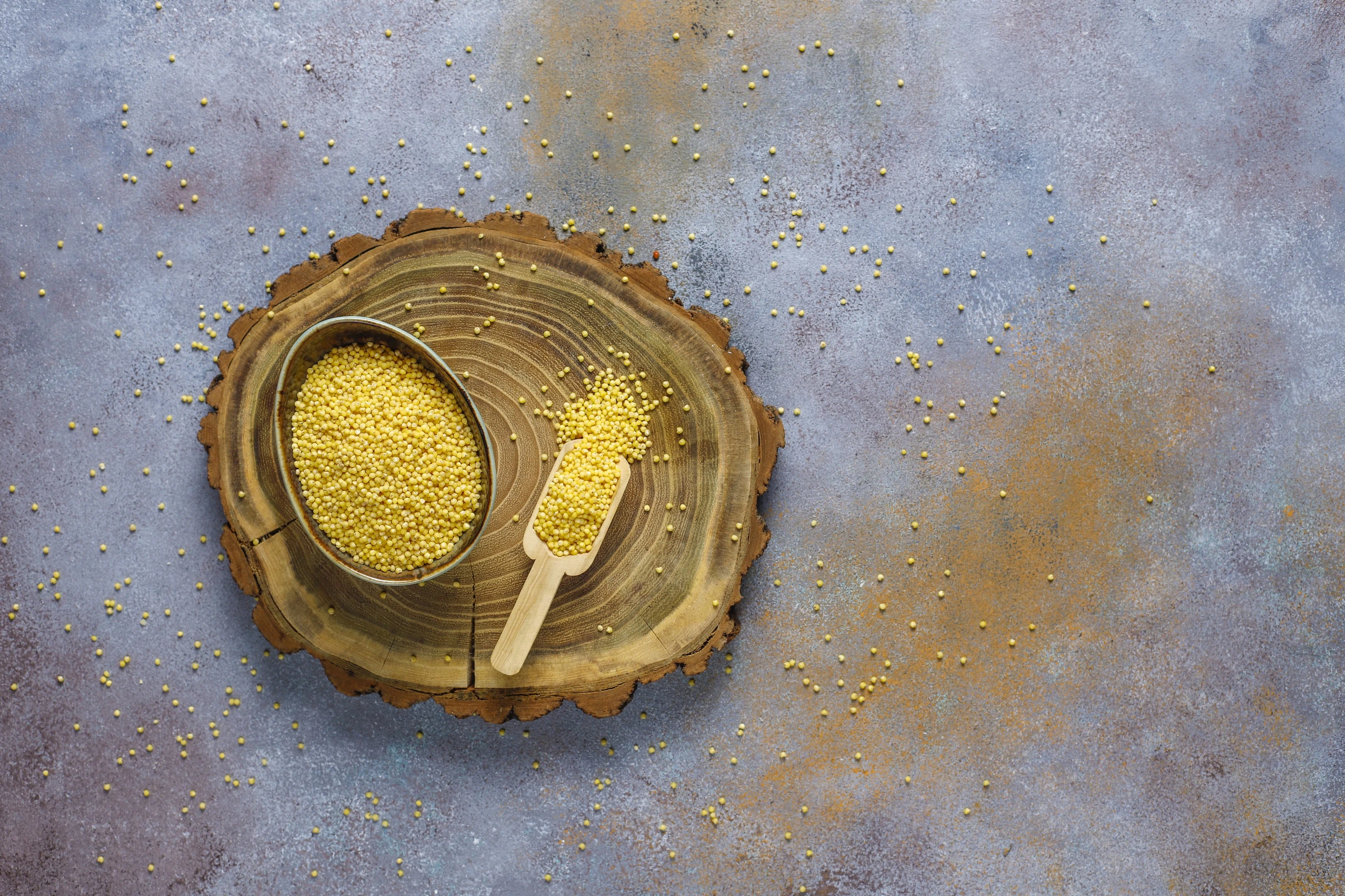 Raw organic foxtail millet on a wooden board
