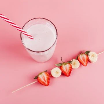 Bahama mama tropical smoothie with a banana strawberry stick