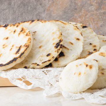 Tasty arepas con queso in different sizes