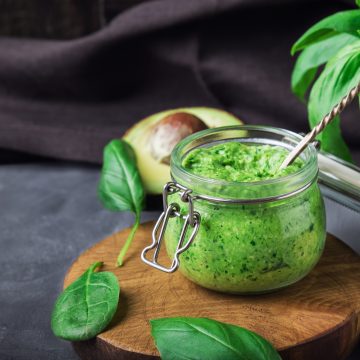 Fresh vegan spinach pesto sauce with basil, cashew nuts, and avocado