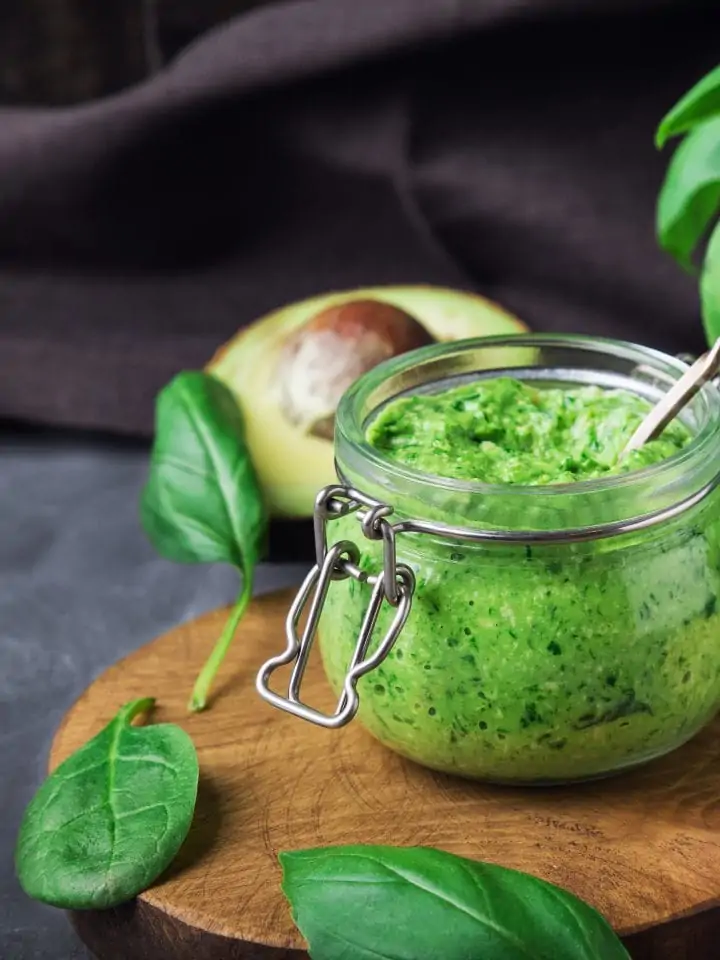 Fresh vegan spinach pesto sauce with basil, cashew nuts, and avocado