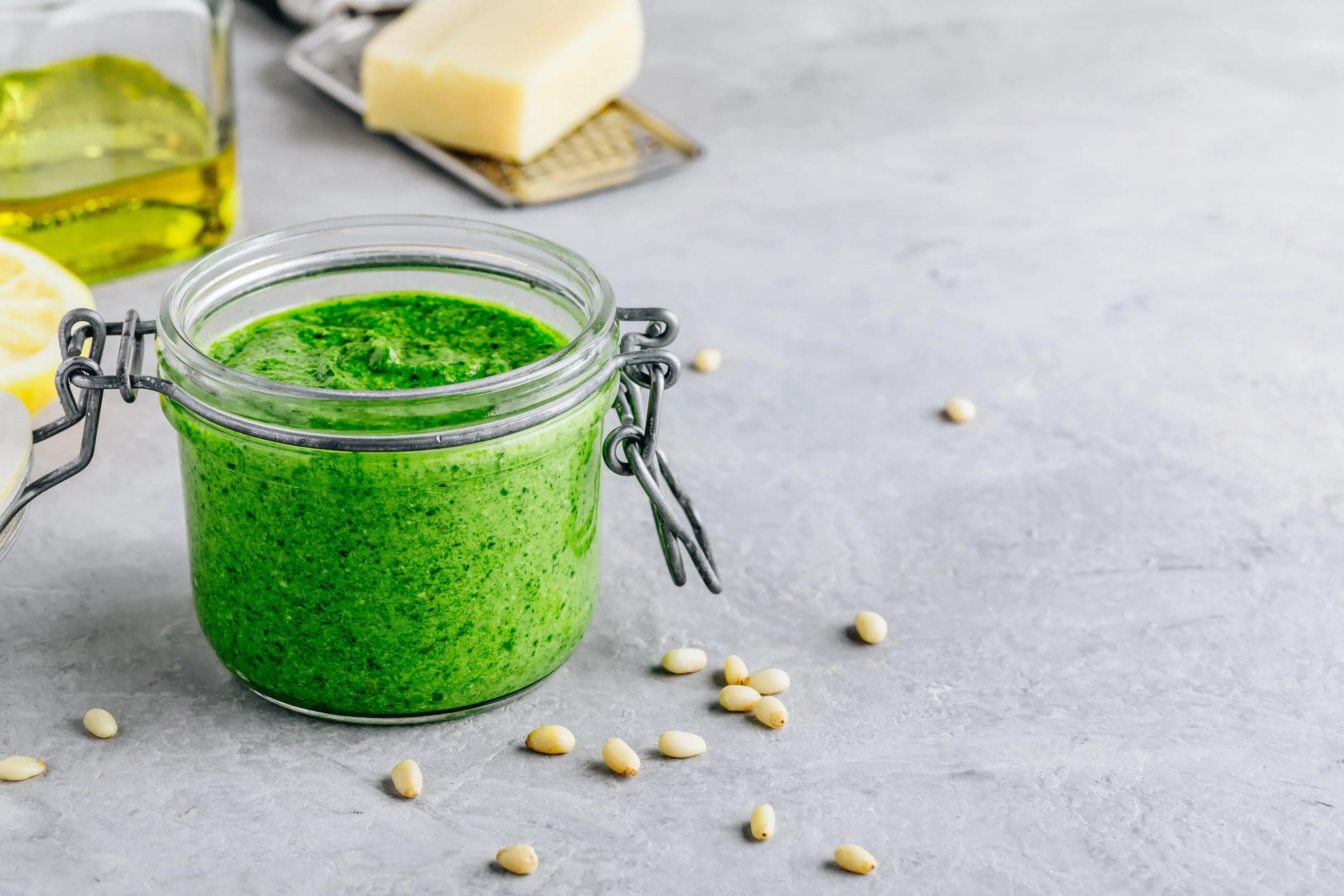 Homemade spinach pesto sauce with parmesan cheese, olive oil, and pine nuts