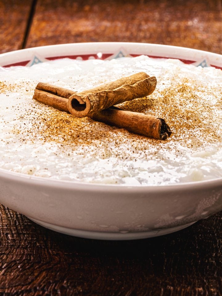 Sweet rice pudding with cooked rice and cinnamon stick