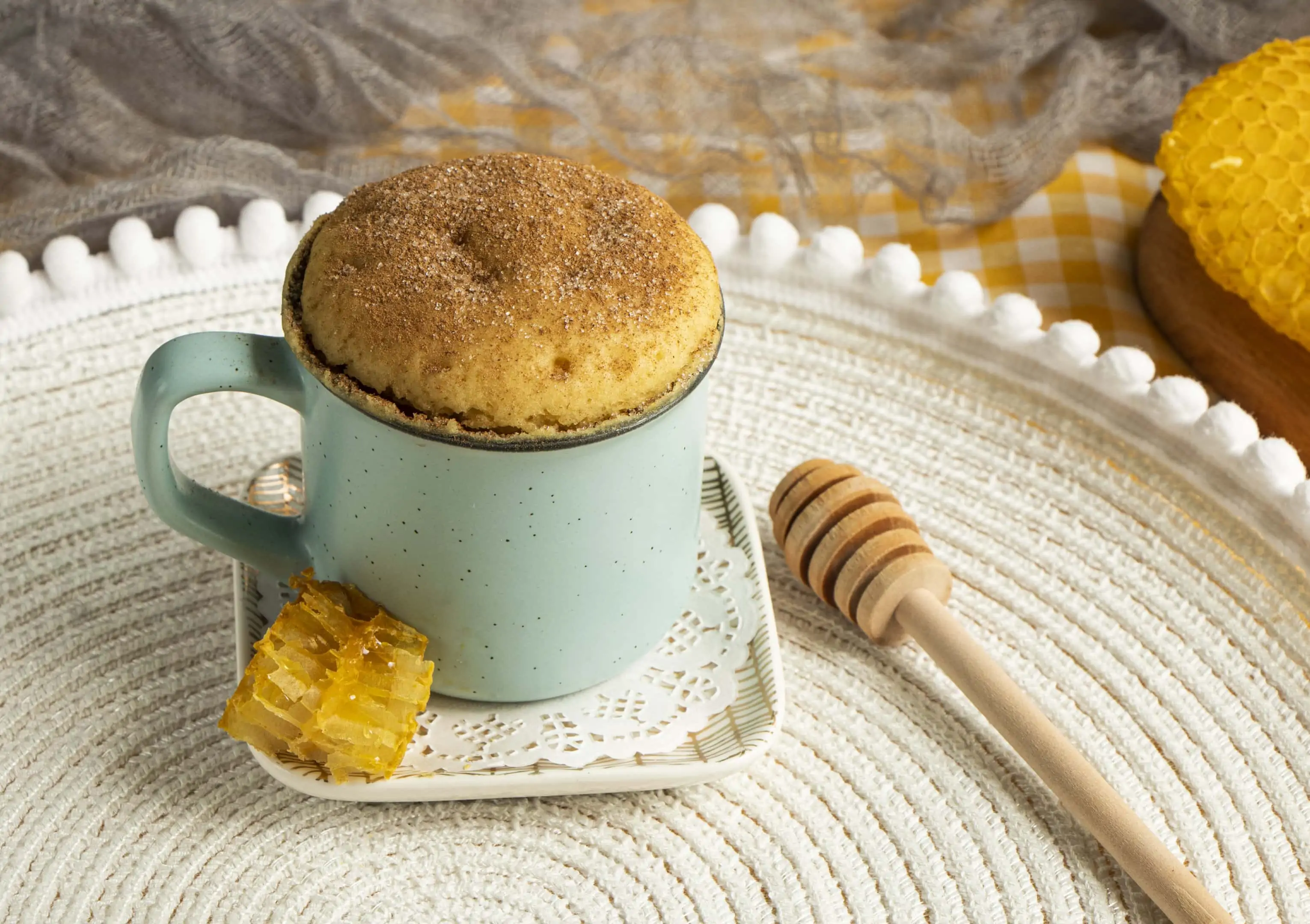Vanilla cake in a mug with cinnamon on top