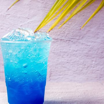 Blue Nuka Cola drink with ice and coconut leaves