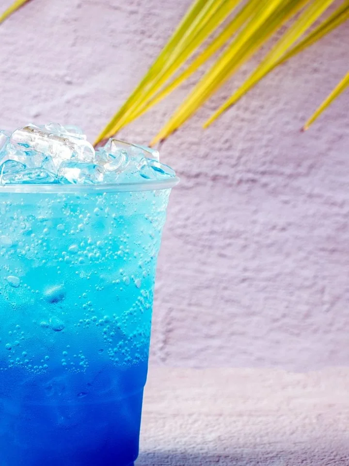 Blue Nuka Cola drink with ice and coconut leaves