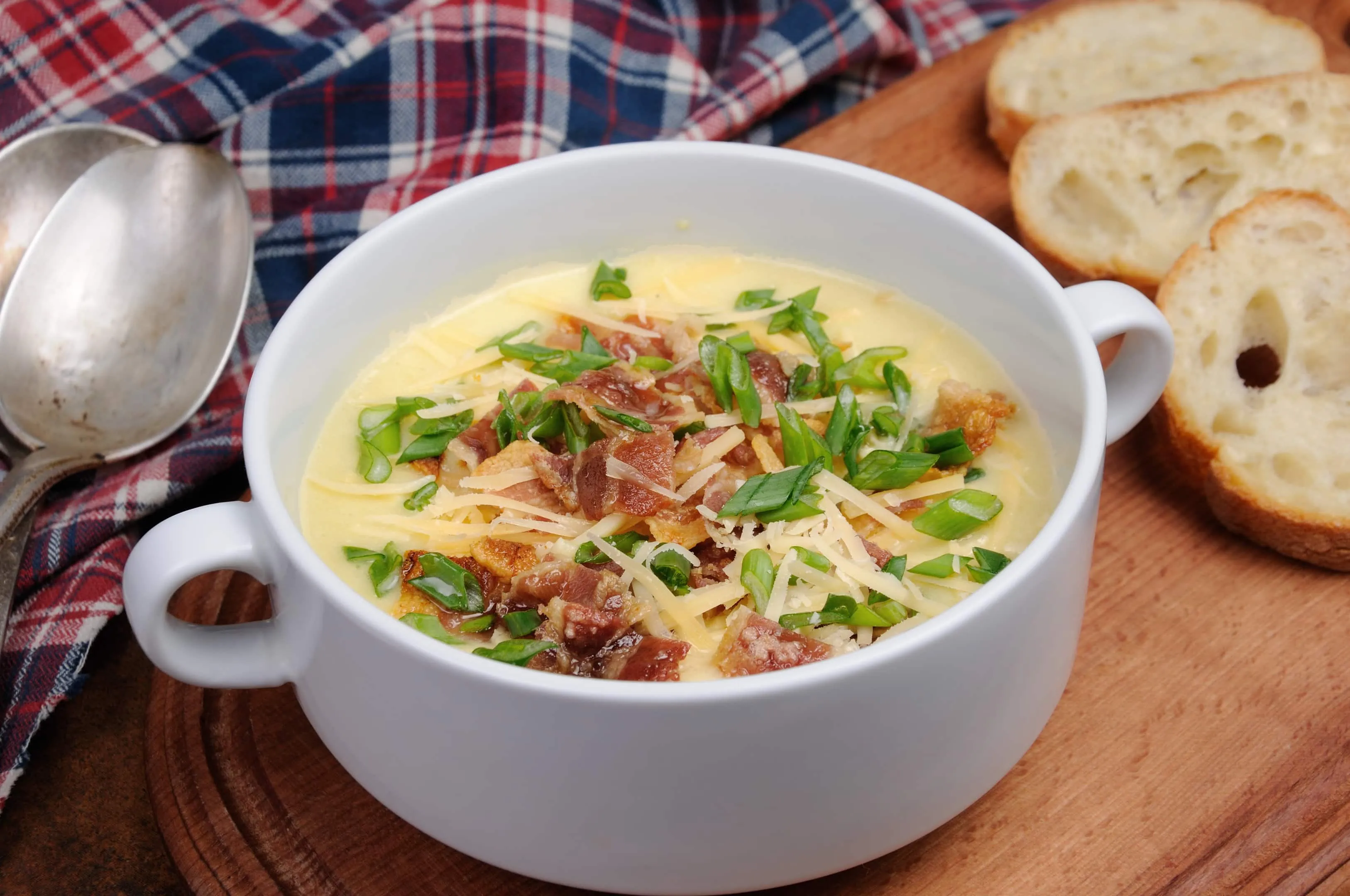 Creamy O'Charley's potato soup recipe with bacon, cheese, and green onions