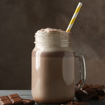 A glass of Herbalife shake with chocolate bars