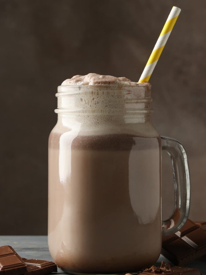 A glass of Herbalife shake with chocolate bars