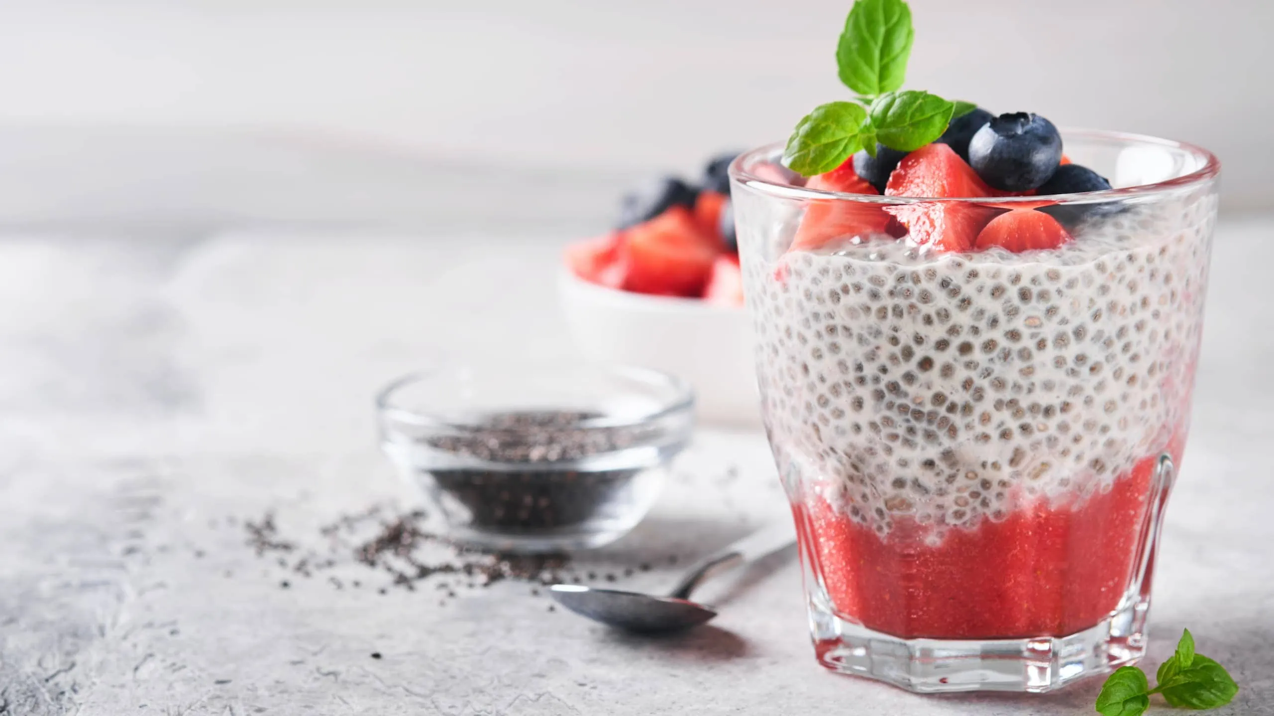 Chia pudding with fresh strawberries, berries, and mint