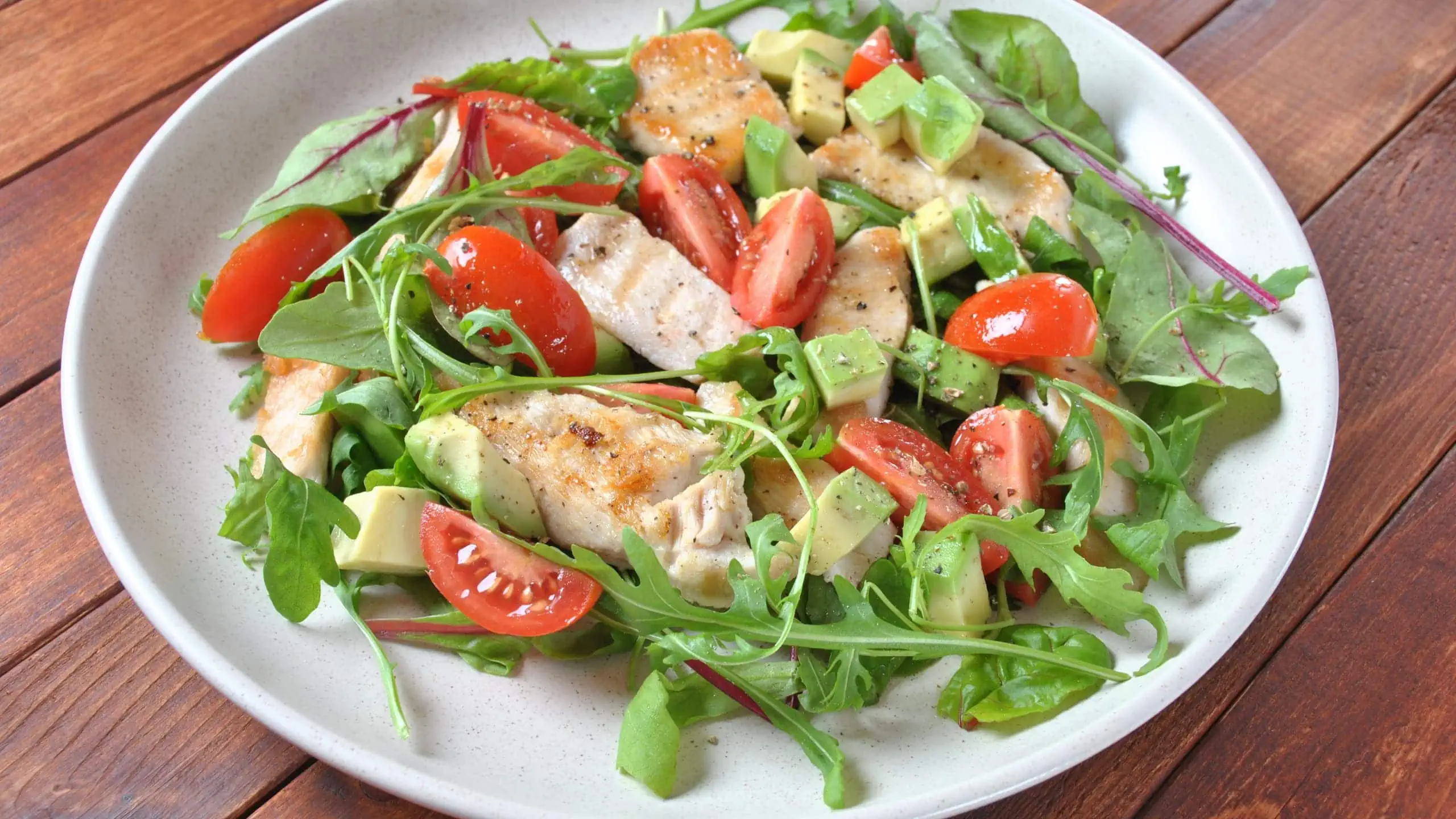 Slimming World chicken salad with avocado, cherry tomatoes, arugula, and beet leaves