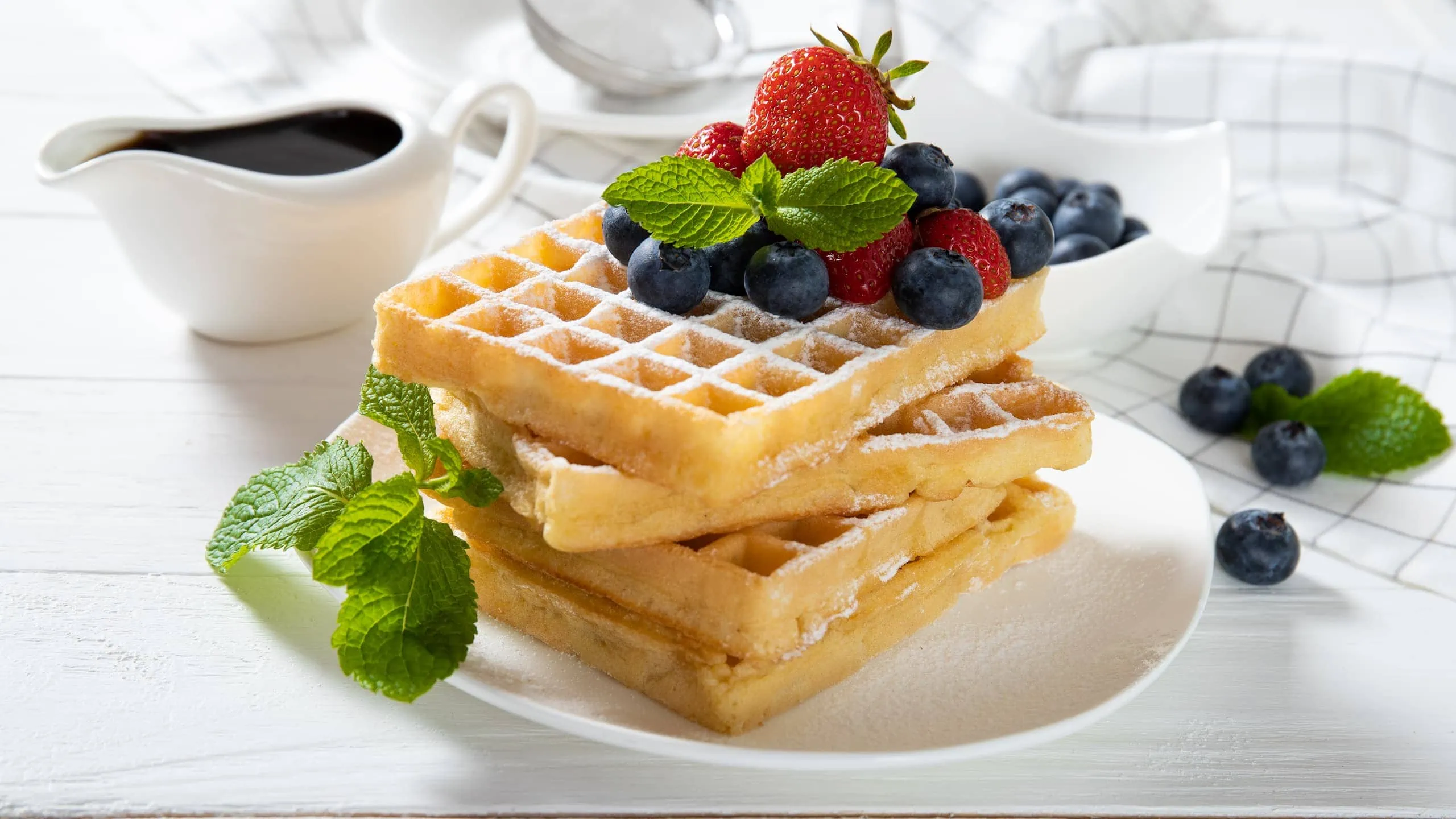 Delicious waffle without baking powder with strawberries, blueberries, and mint