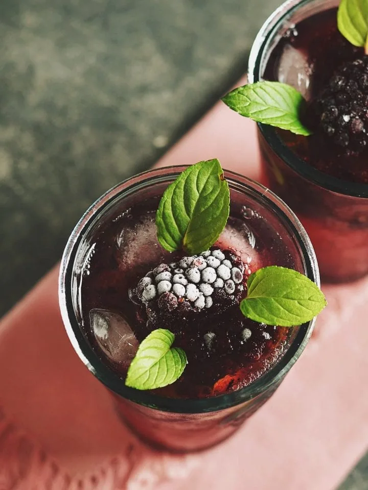 Homemade blackberry moonshine garnished with mint